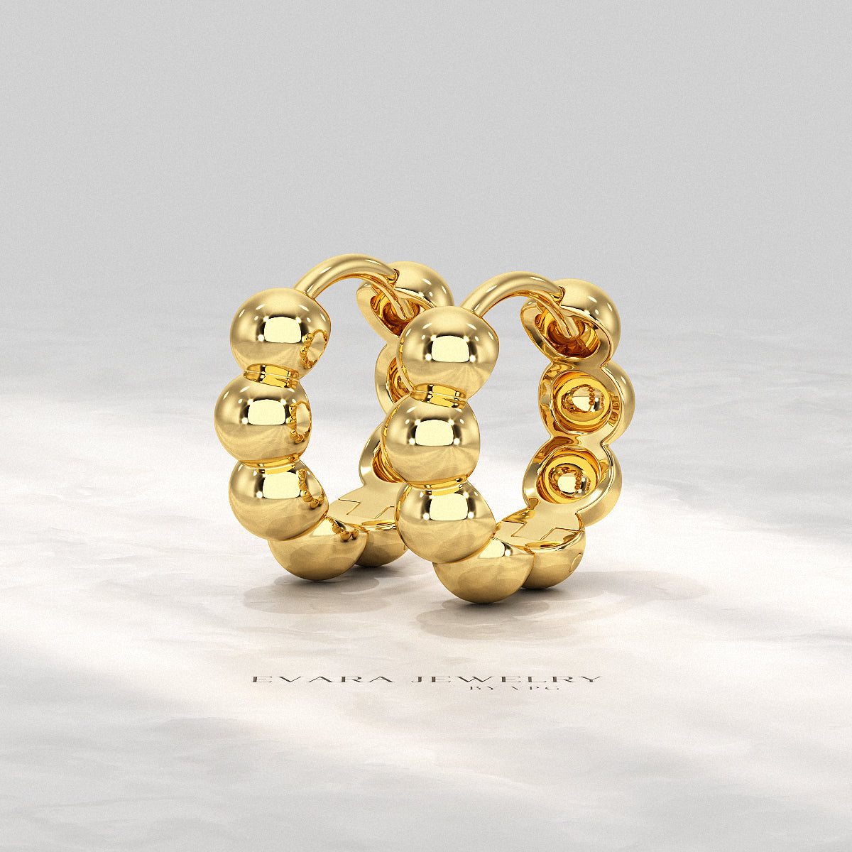 Close-up of light reflecting off the curved bubble beads on the hoop earrings.