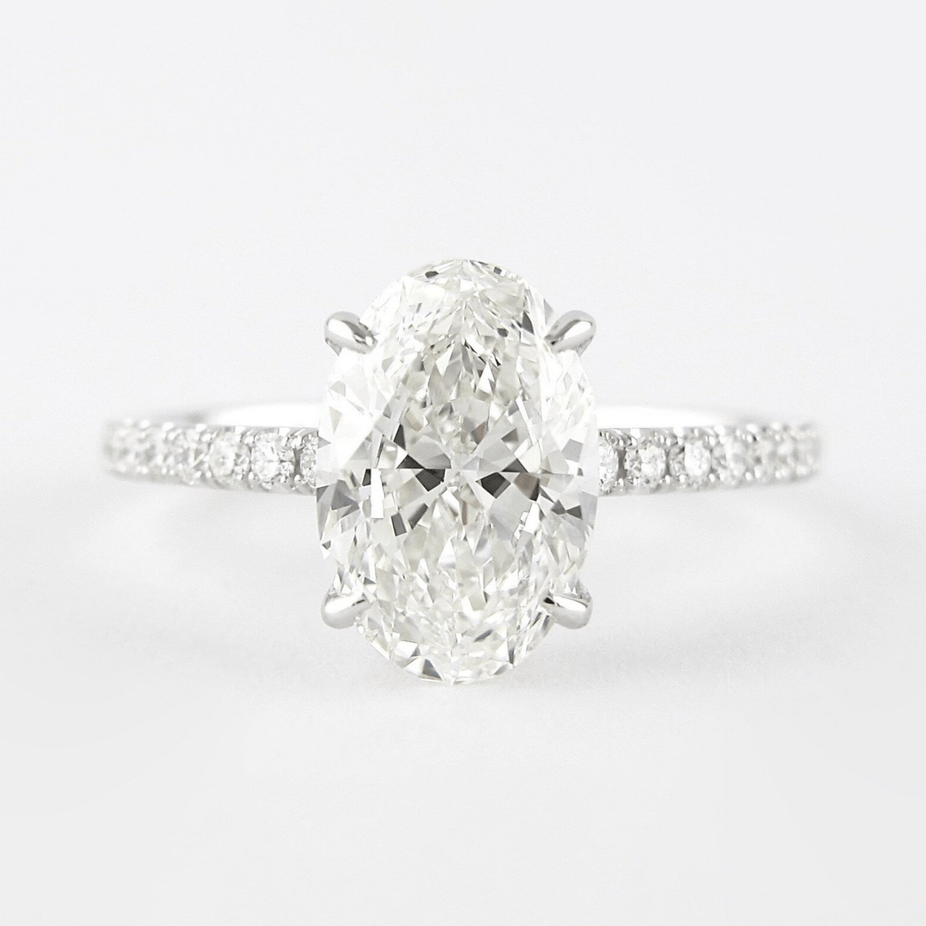 2.50 Carat Oval Cut Prong Set Lab Grown Diamond Engagement Ring with Pave Diamond Band - Evara Jewelry LLC