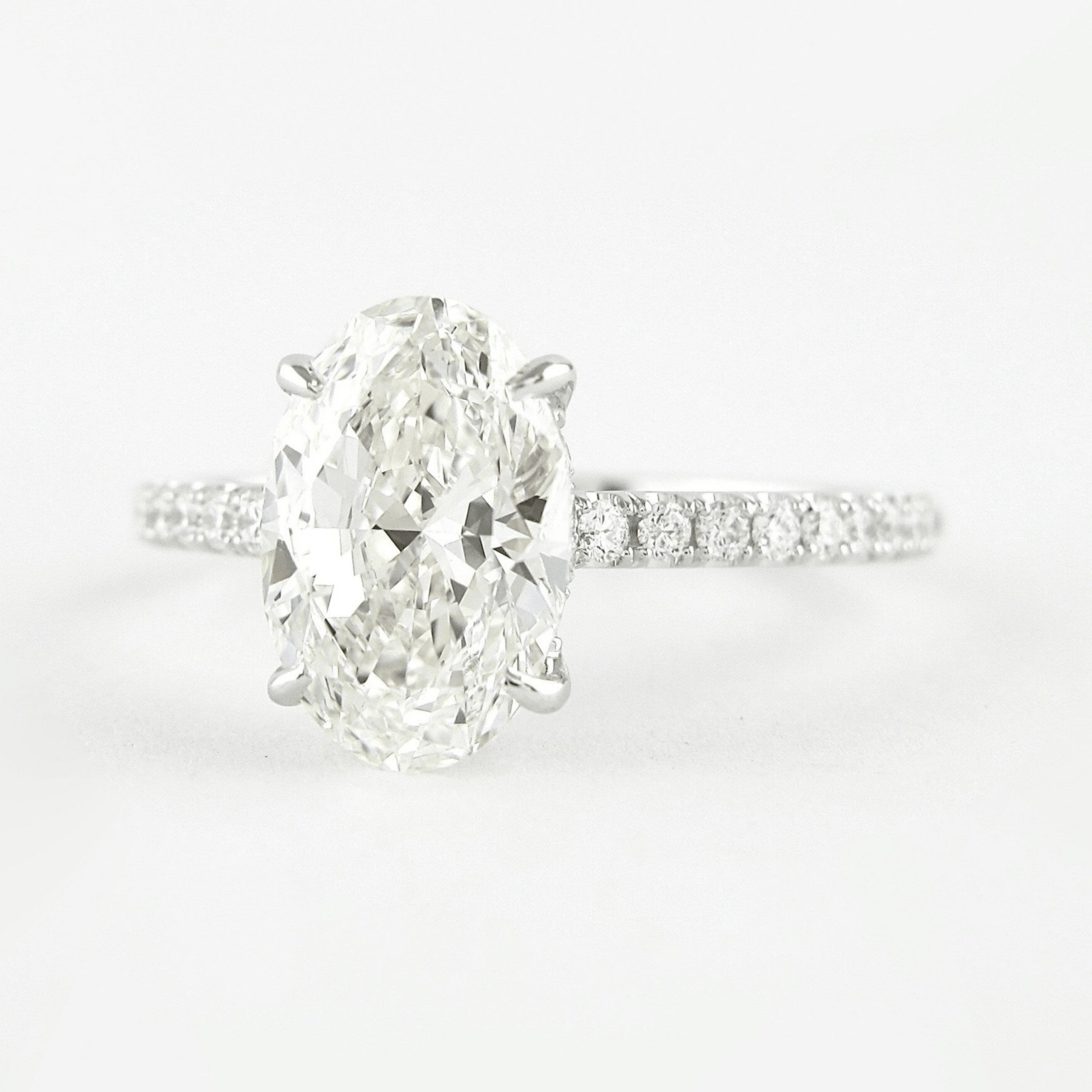 2.50 Carat Oval Cut Prong Set Lab Grown Diamond Engagement Ring with Pave Diamond Band - Evara Jewelry LLC