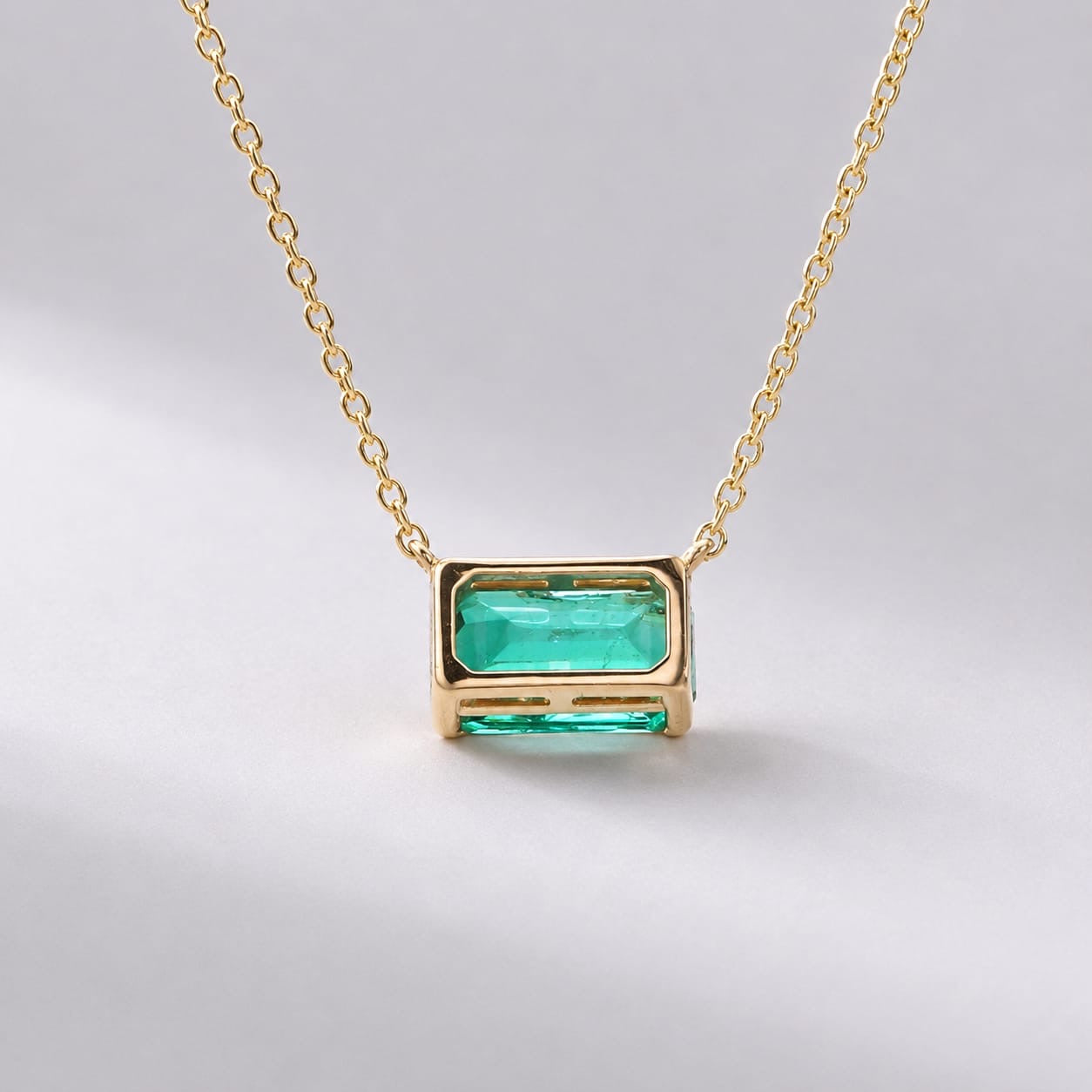 Natural East-West Emerald-Cut Emerald Pendant Necklace in 14K Gold