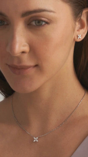 Close-up of diamond floral earrings featuring lab-created marquise stones